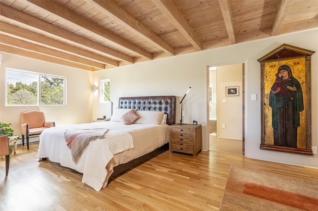 bedroom with beam ceiling, light wood-type flooring, a baseboard radiator, and wooden ceiling