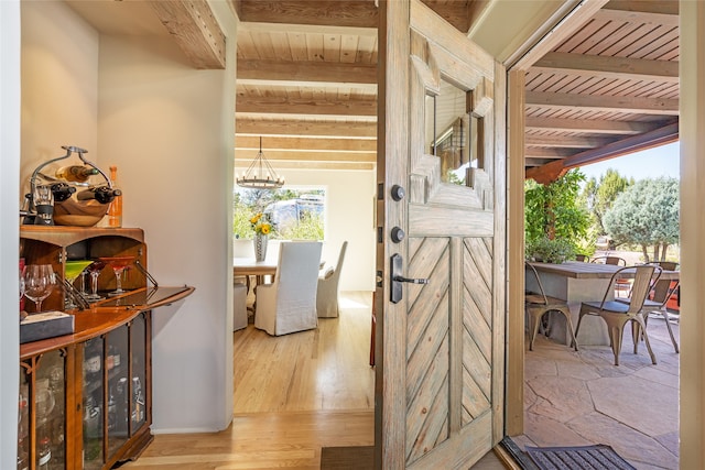 interior space with beamed ceiling, hardwood / wood-style flooring, and wooden ceiling