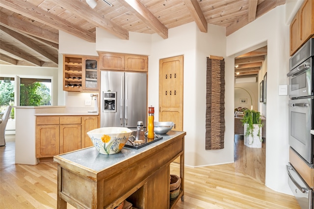 kitchen with beam ceiling, wooden ceiling, light wood-type flooring, and appliances with stainless steel finishes