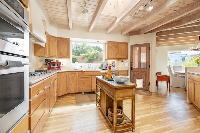 kitchen with beam ceiling, wooden ceiling, rail lighting, and light hardwood / wood-style flooring