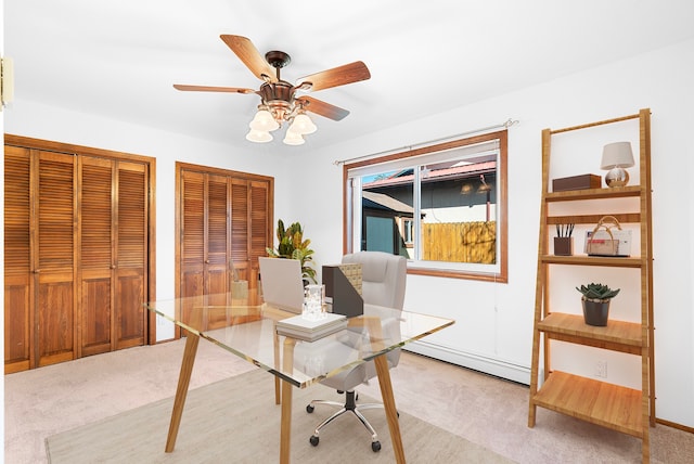 carpeted office space with ceiling fan and baseboard heating