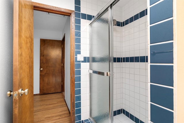 bathroom featuring walk in shower and hardwood / wood-style flooring