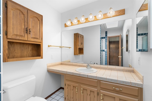 bathroom with vanity, toilet, and tile patterned floors