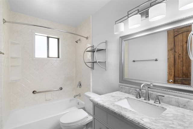 full bathroom featuring vanity, toilet, and tiled shower / bath