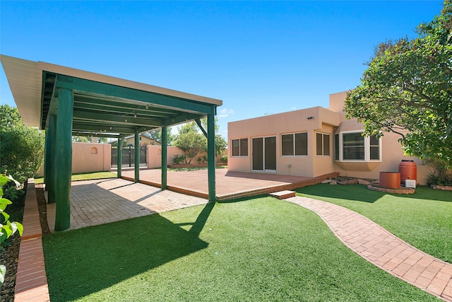 back of house featuring a patio and a yard