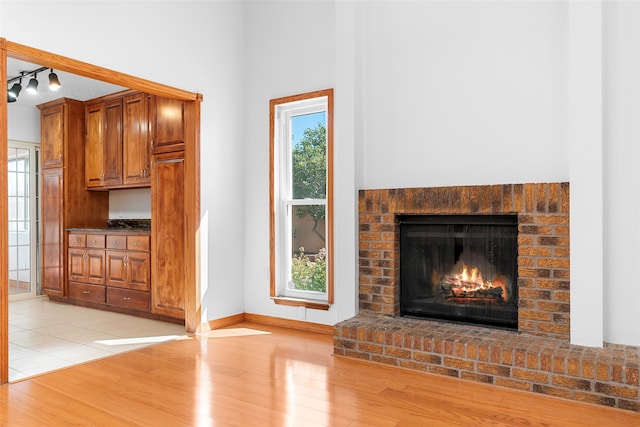 unfurnished living room featuring light hardwood / wood-style flooring and a fireplace