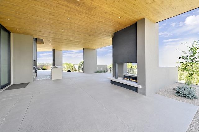 view of patio with an outdoor fireplace