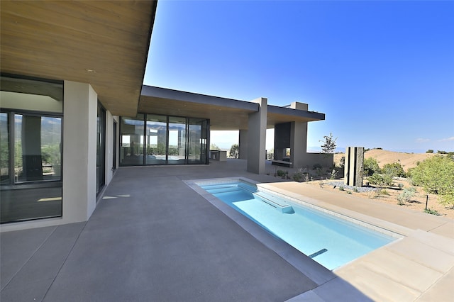 view of pool featuring a mountain view and a patio area