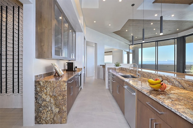 kitchen with dishwasher, a water view, dark stone countertops, and sink