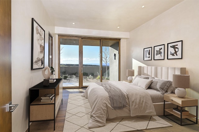 bedroom featuring light wood-type flooring and access to outside