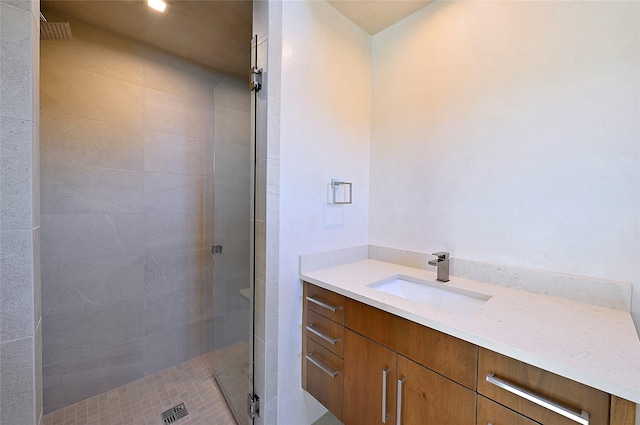 bathroom featuring vanity and a shower with door