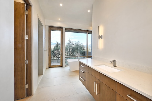 bathroom featuring vanity, tile patterned floors, and a bathtub