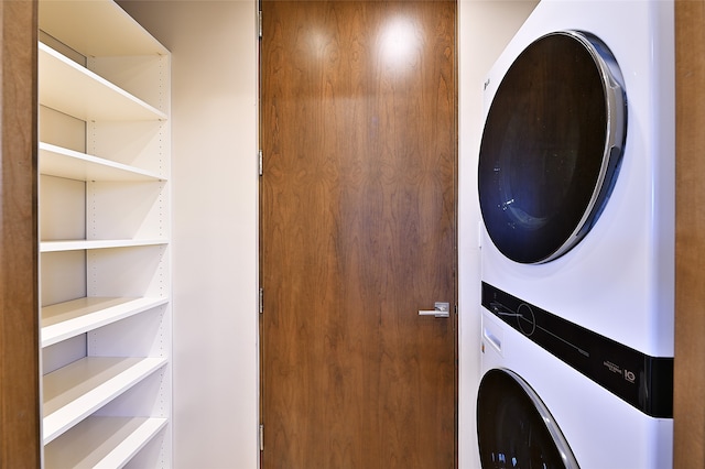 laundry room with stacked washer / drying machine