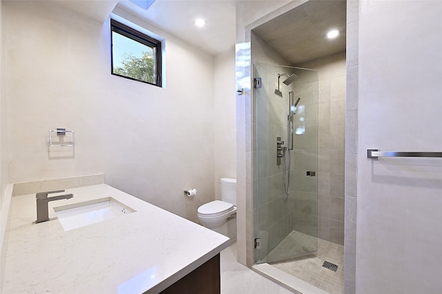 bathroom featuring vanity, an enclosed shower, and toilet