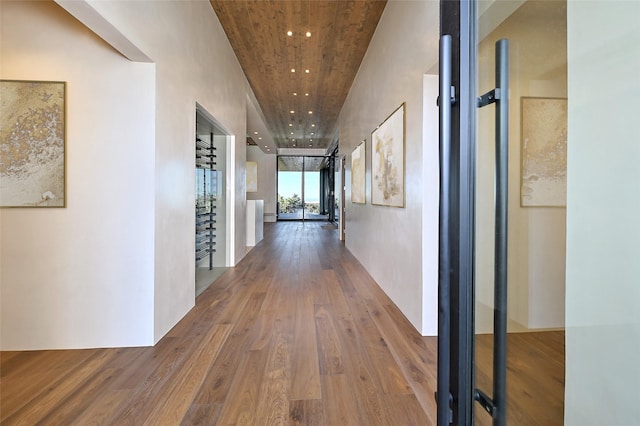 corridor featuring hardwood / wood-style flooring and expansive windows