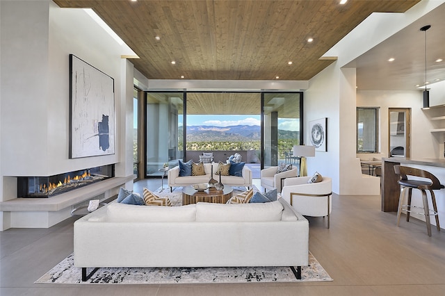 living room featuring concrete floors and wooden ceiling