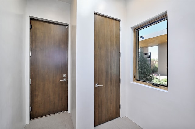 hall featuring light tile patterned floors