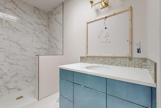 bathroom featuring decorative backsplash, a tile shower, and vanity