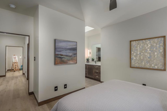 bedroom featuring ensuite bath and light hardwood / wood-style flooring