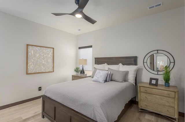 bedroom with light hardwood / wood-style floors and ceiling fan