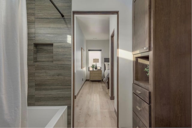 bathroom with plus walk in shower and hardwood / wood-style flooring