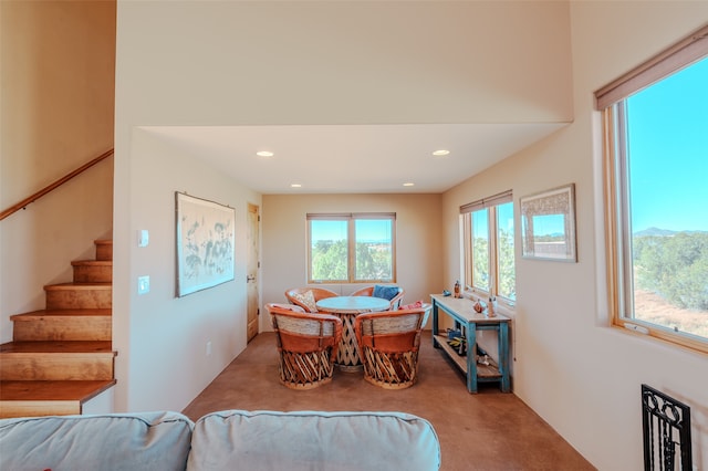 dining space featuring light carpet, a mountain view, and a wealth of natural light