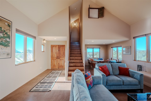 living room with high vaulted ceiling