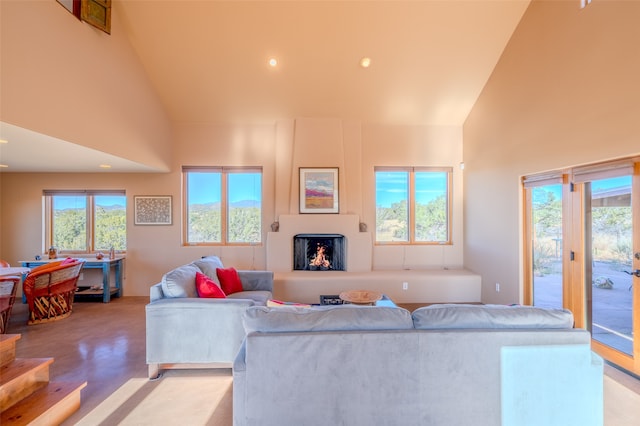 living room featuring high vaulted ceiling and a wealth of natural light