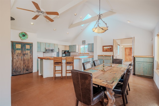 dining area with sink, high vaulted ceiling, and ceiling fan