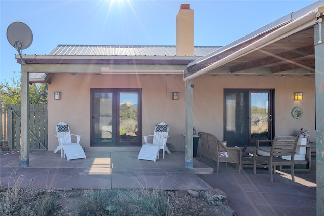 rear view of property with a patio and an outdoor living space