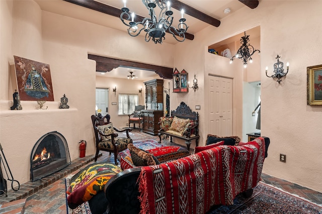 living room with a brick fireplace, a chandelier, and beamed ceiling