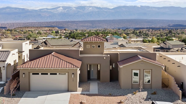 view of front of property featuring a mountain view and a garage