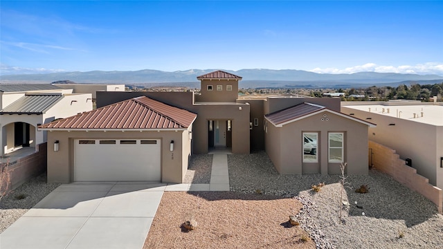 view of front of home with a mountain view and a garage