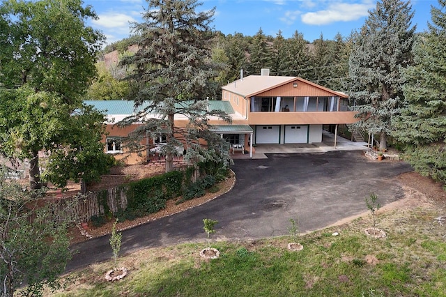 view of front of house with a carport and a garage