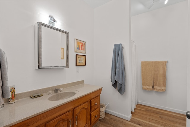 bathroom with hardwood / wood-style floors and vanity