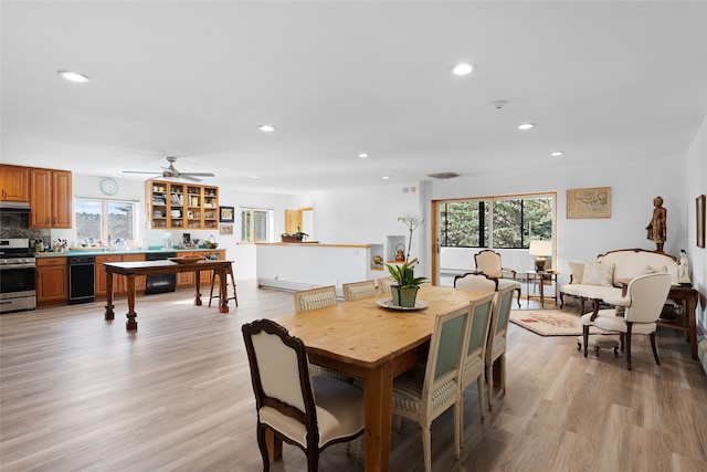 dining area featuring ceiling fan, light hardwood / wood-style floors, and a healthy amount of sunlight