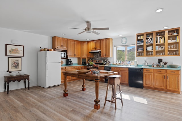 kitchen featuring appliances with stainless steel finishes, backsplash, light hardwood / wood-style floors, and ceiling fan