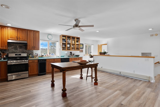 kitchen featuring black dishwasher, baseboard heating, light hardwood / wood-style floors, and stainless steel range oven