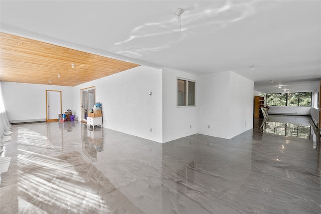 unfurnished living room featuring wooden ceiling