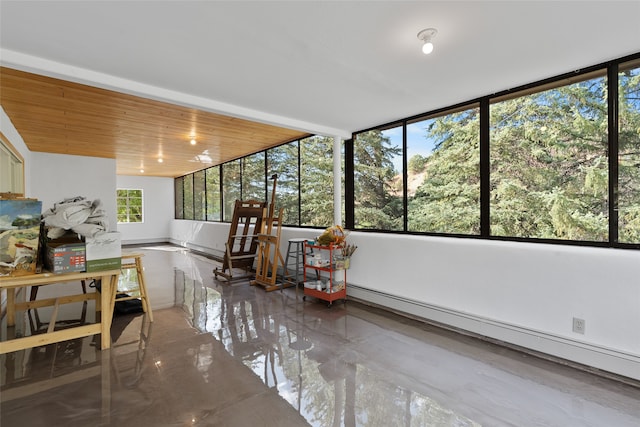 unfurnished sunroom featuring a baseboard heating unit