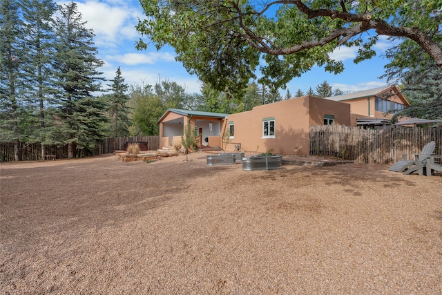 back of house featuring a patio area and an outdoor fire pit