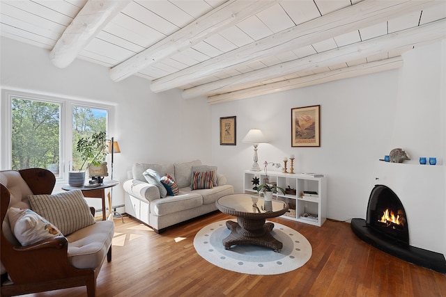 living room with a baseboard heating unit, wooden ceiling, beam ceiling, and hardwood / wood-style flooring