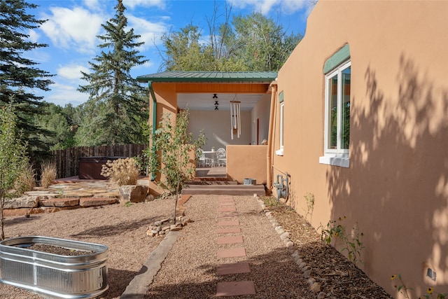 view of property exterior featuring ceiling fan and a patio area