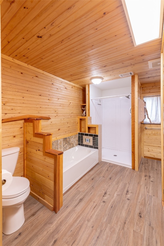 bathroom with separate shower and tub, wood-type flooring, wooden walls, wooden ceiling, and toilet