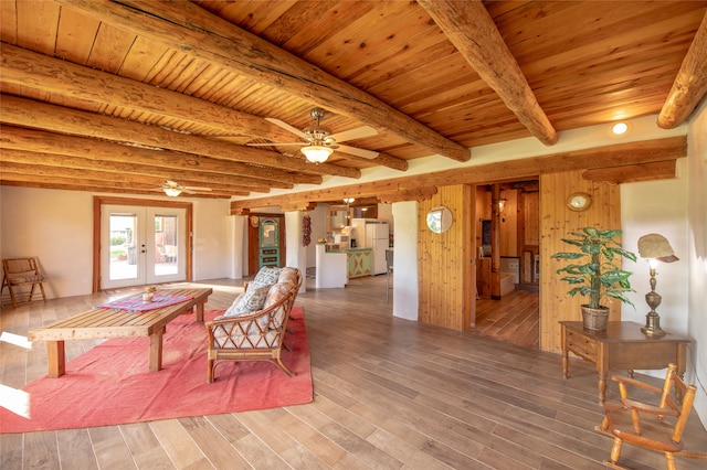 living room featuring beam ceiling, hardwood / wood-style floors, ceiling fan, wooden ceiling, and french doors