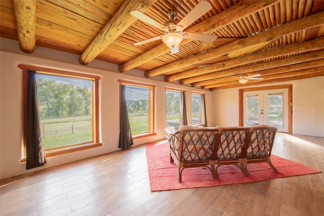 interior space with french doors, wood ceiling, beam ceiling, and a wealth of natural light