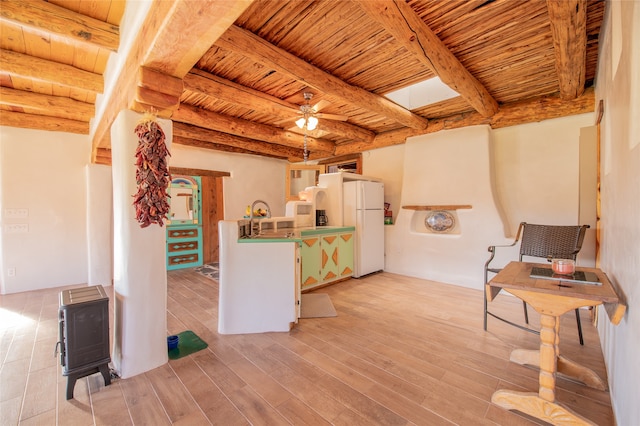 kitchen featuring white refrigerator, wood ceiling, light wood-type flooring, and beam ceiling