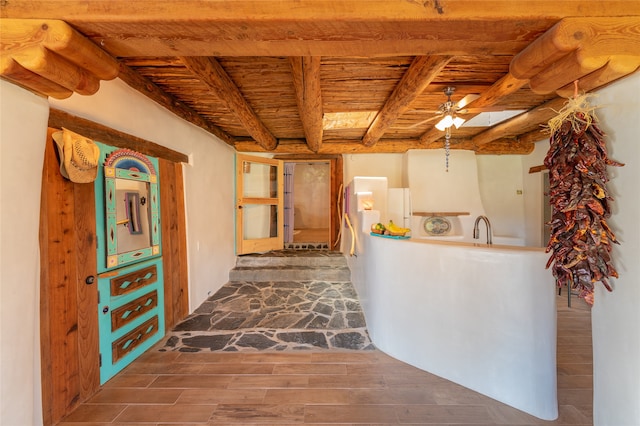 kitchen with ceiling fan, beamed ceiling, dark hardwood / wood-style flooring, and wooden ceiling