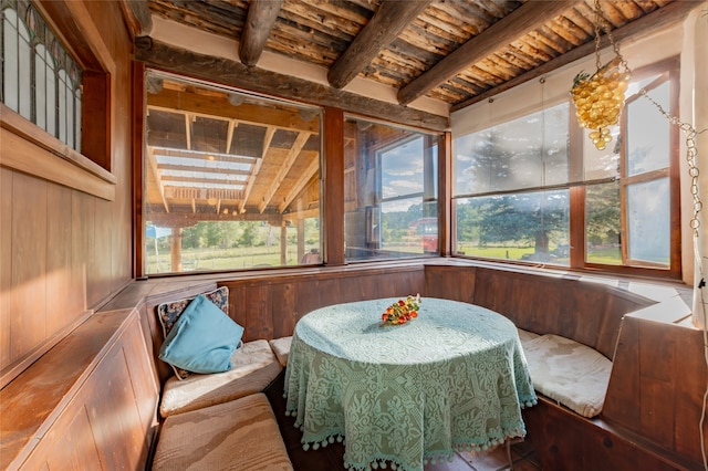 sunroom / solarium featuring beamed ceiling and wooden ceiling