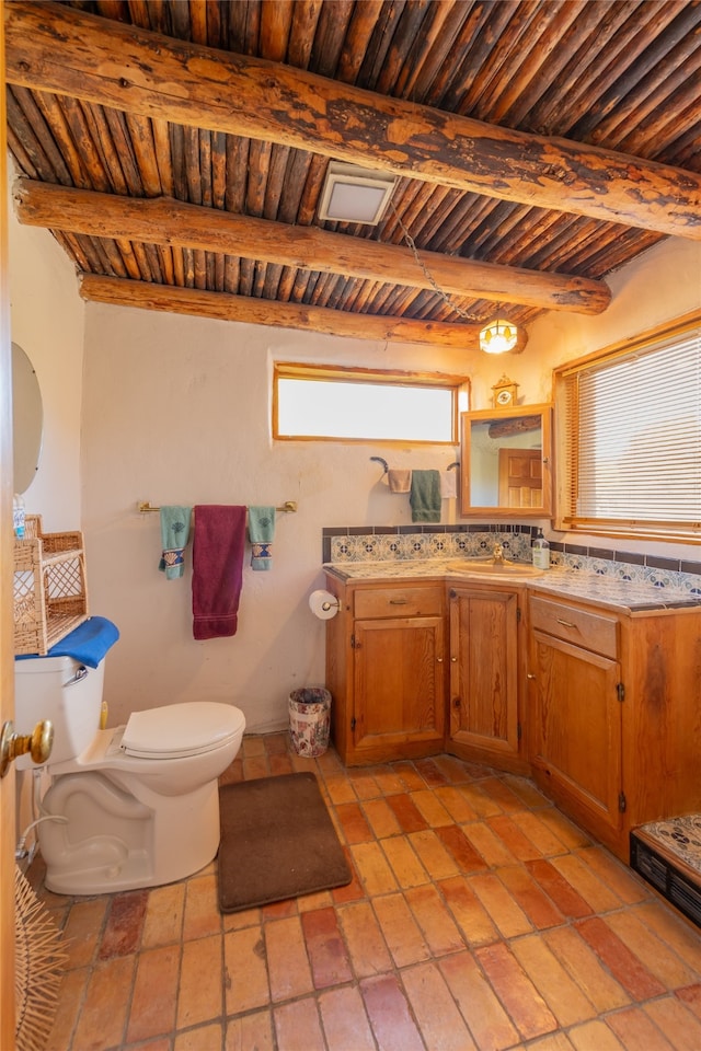 bathroom with wooden ceiling, vanity, toilet, and beamed ceiling